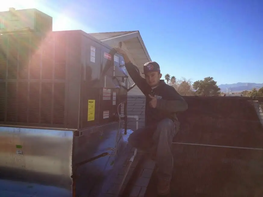 HVAC technician performing HVAC Inspection on a rooftop unit in Culpeper